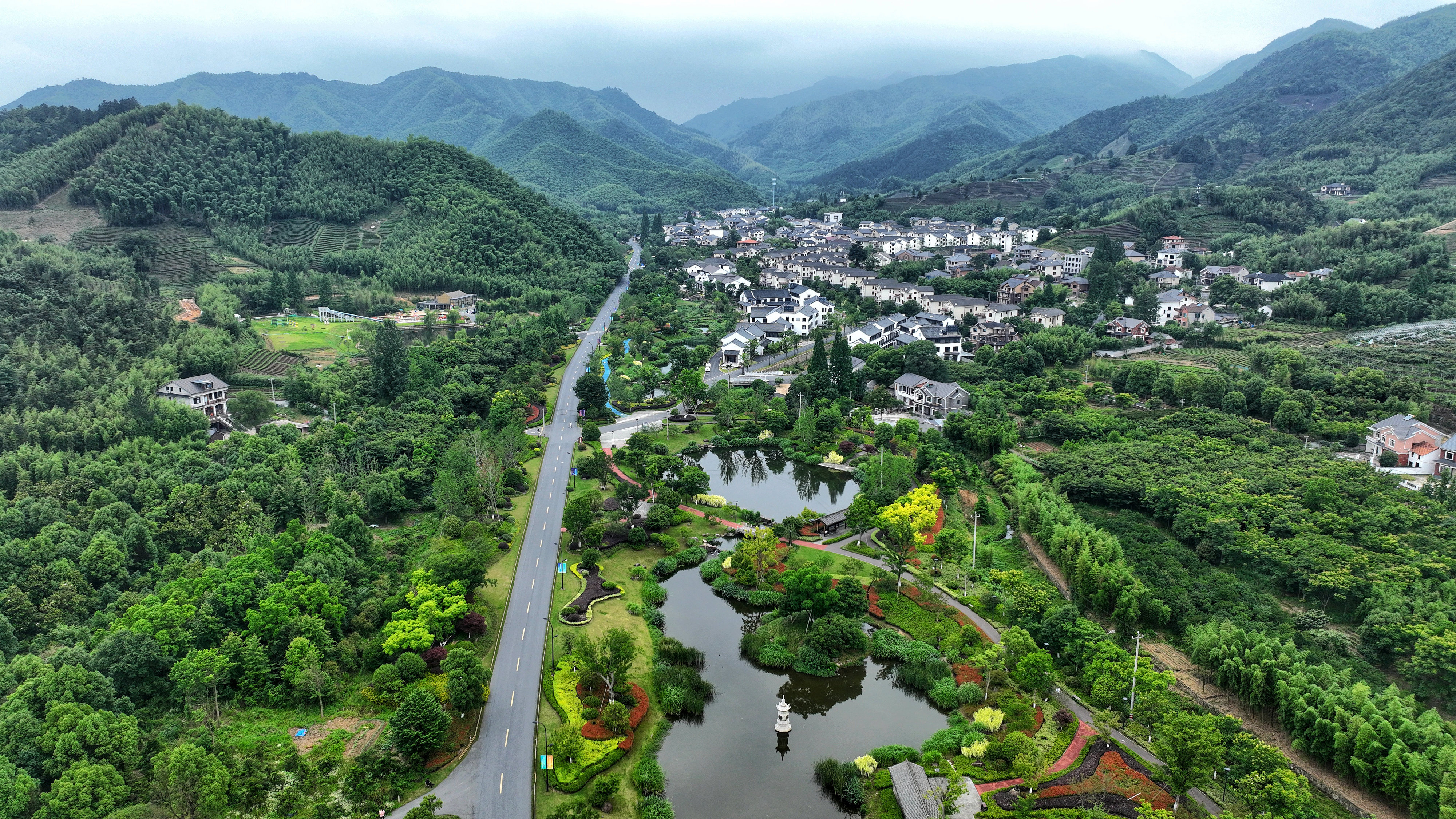 2023年6月6日，杭州余杭區(qū)徑山鎮(zhèn)鄉(xiāng)村，生態(tài)碧水、沿路花海與村莊農(nóng)房相映成趣，構(gòu)成一幅美麗的山水田園畫。